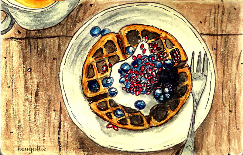 Waffles with creme, blueberries, and pomegranate